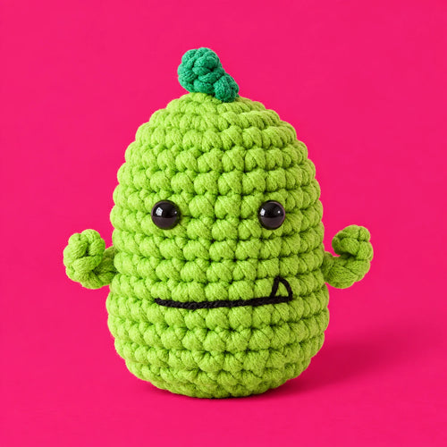 Fred — Dinosaure au crochet vert, vu de face.