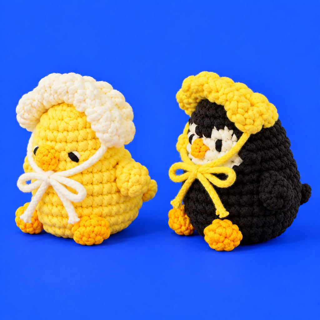Pia & Paco — Poussin et pingouin avec bonnets au crochet — vue de trois quarts.
